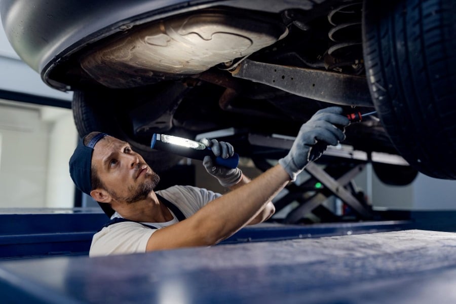 Diesel Truck Maintenance Service 1 mechanic checking truck with flashlight